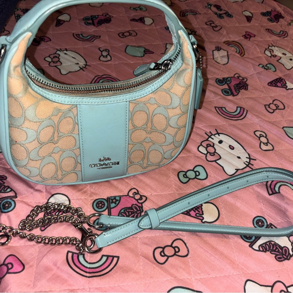 This is a Carmen shoulder bag in signature jacquard, coach bag, in a light blue
